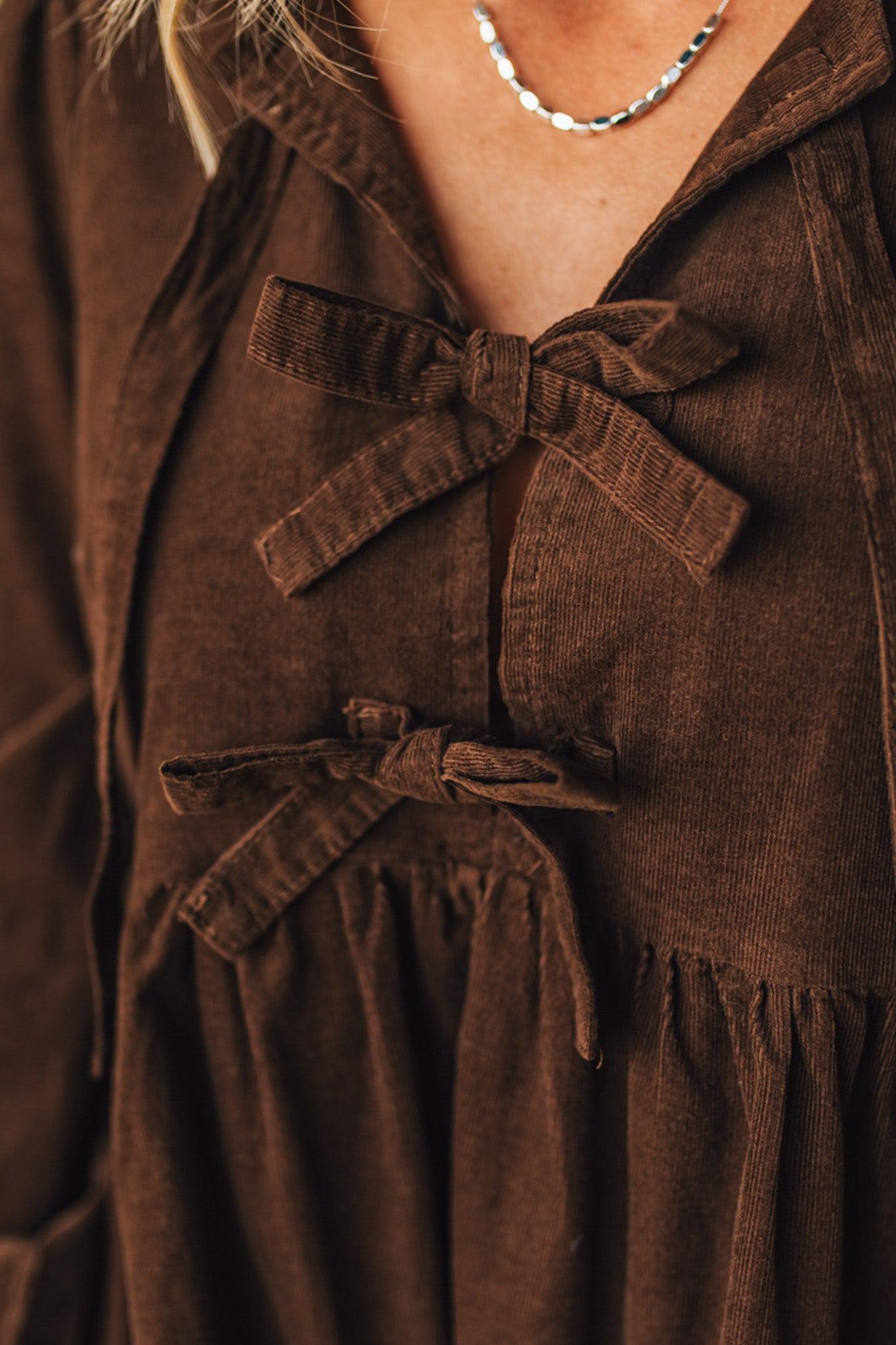 Brown corduroy dress with a belt and close-up of neckline