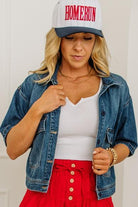 Woman wearing a denim jacket, white top, red skirt, and 'HOMERUN' cap.