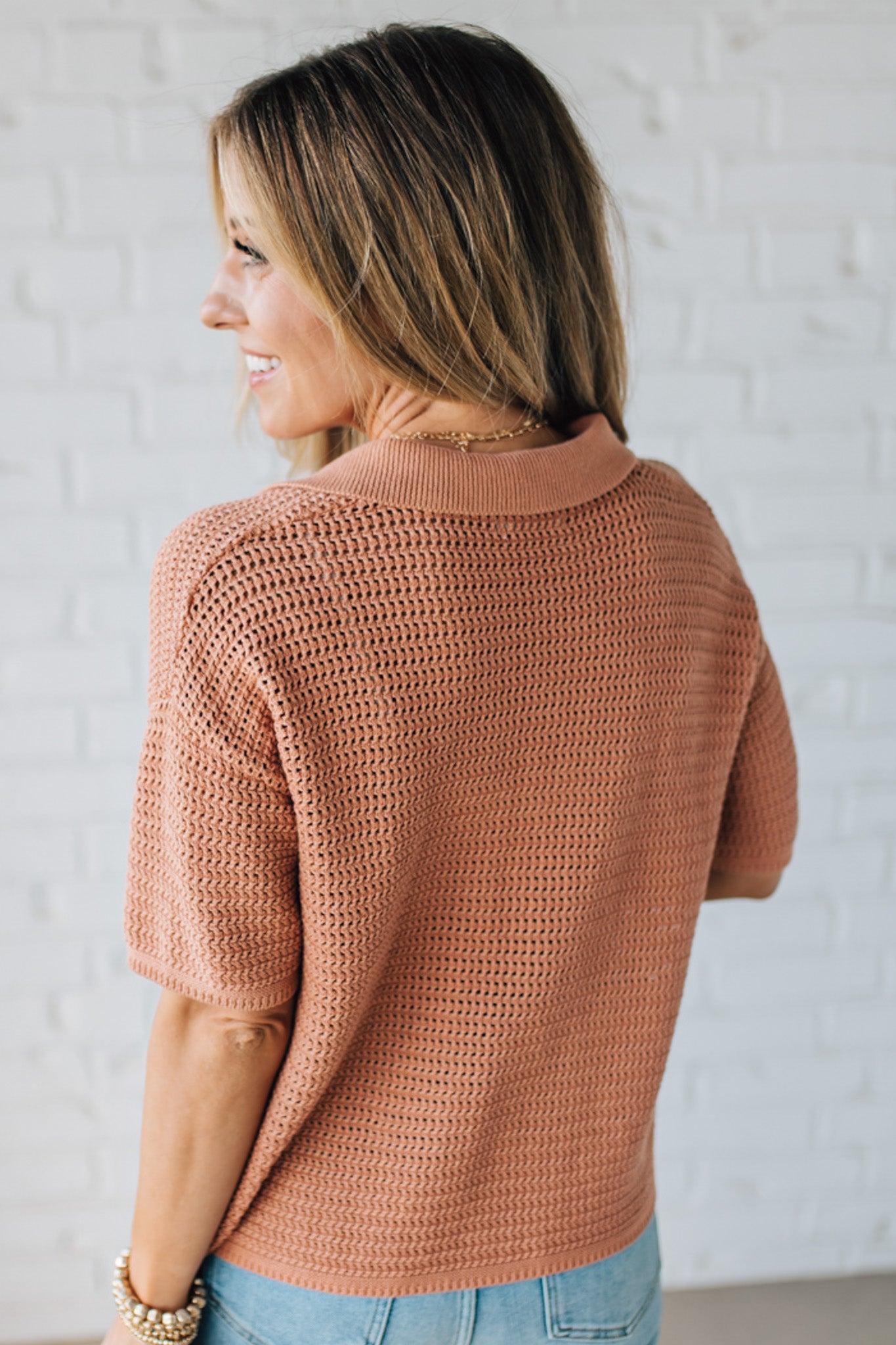 Blonde Woman Wearing a Boxy Crochet Button Up Sweater Shirt in the Color Dusty Peach.