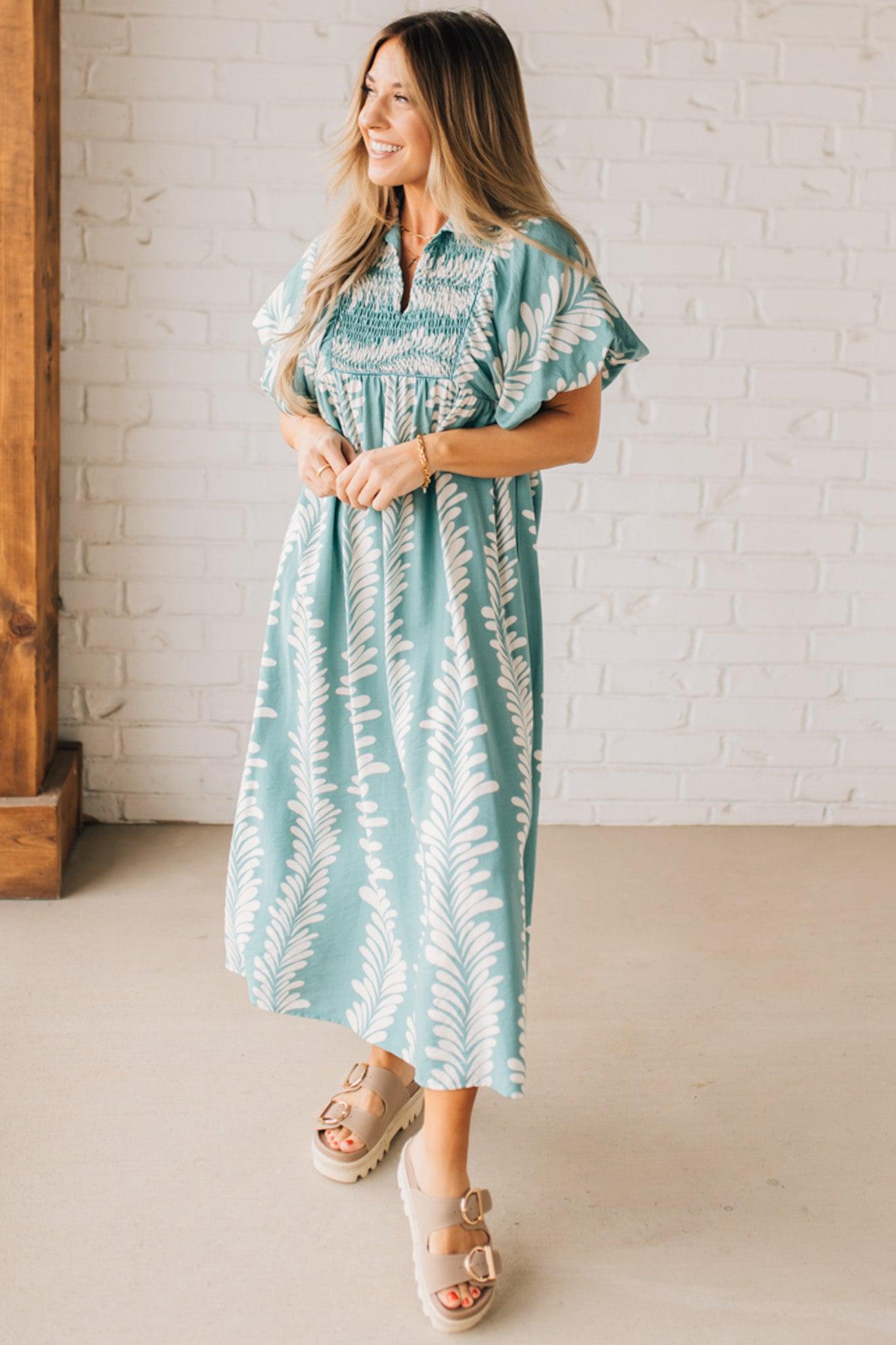 Blonde woman wearing a Printed Short Puff Sleeve Midi Dress with a Smocked Front Yoke.