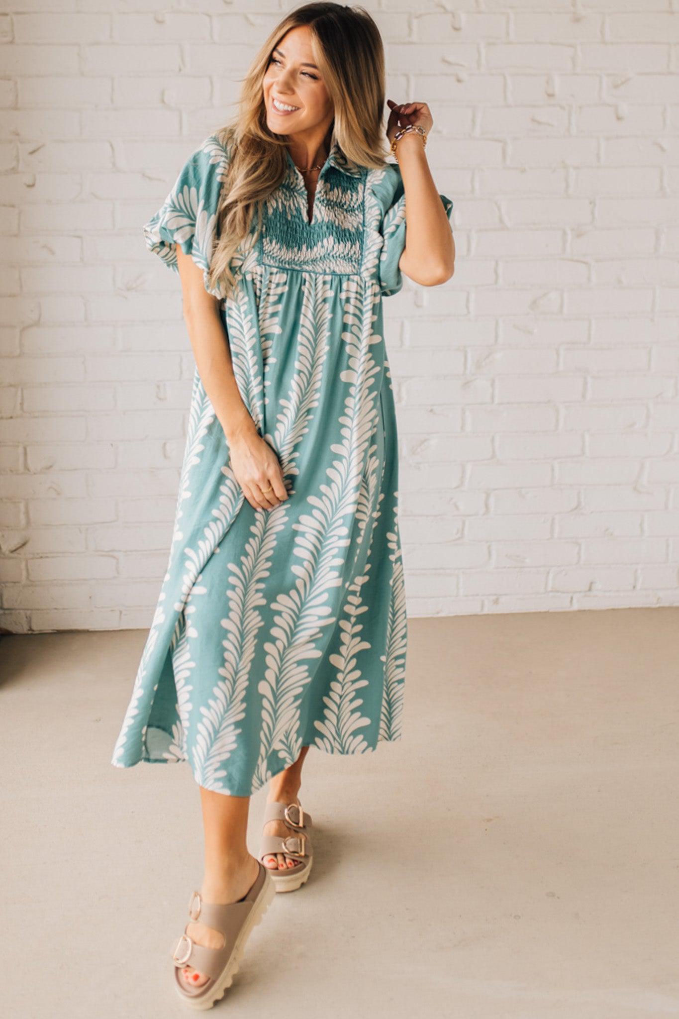 Blonde woman wearing a Printed Short Puff Sleeve Midi Dress with a Smocked Front Yoke.