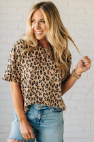Blonde Woman Wearing a Loose Fit Leopard Print Round Neck Knit Top.