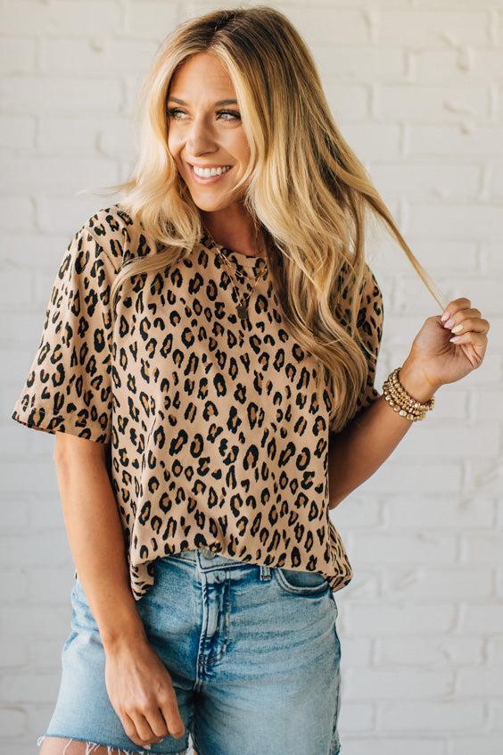 Blonde Woman Wearing a Loose Fit Leopard Print Round Neck Knit Top.