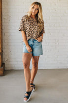 Blonde Woman Wearing a Loose Fit Leopard Print Round Neck Knit Top.