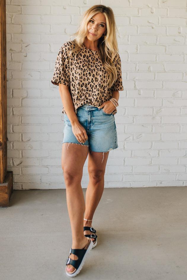 Blonde Woman Wearing a Loose Fit Leopard Print Round Neck Knit Top.