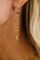 Paperclip Chain Dangle Design: Features double-strand paperclip link chains dangling in asymmetrical lengths for fluid movement.