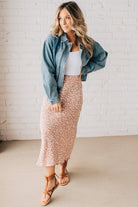 Blonde woman wearing a floral lightweight midi skirt.