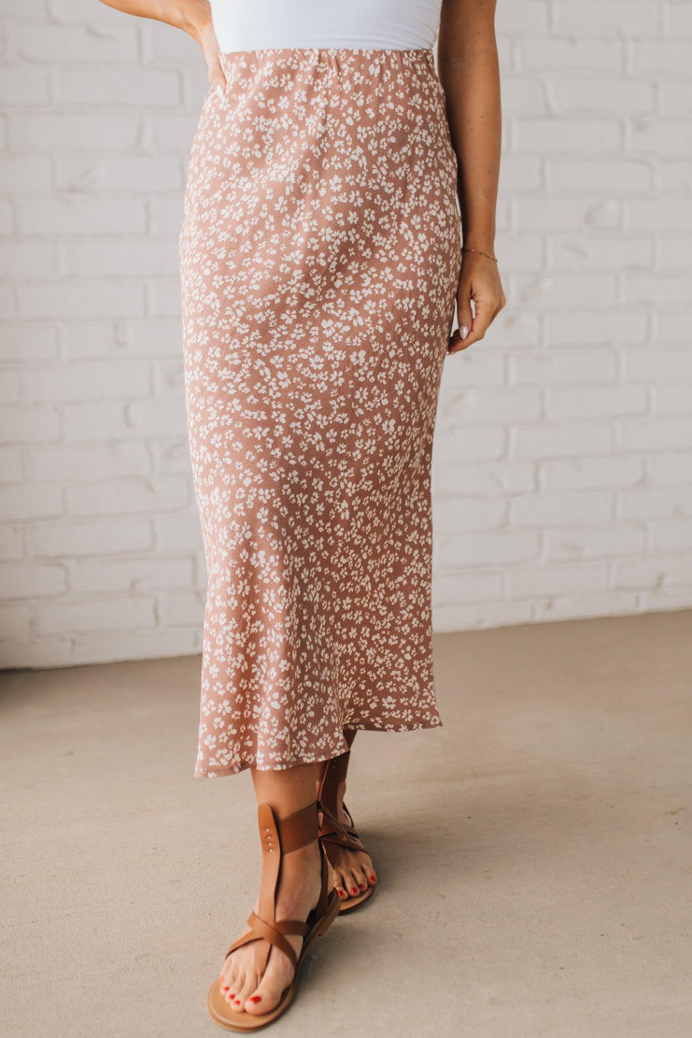 Blonde woman wearing a floral lightweight midi skirt.