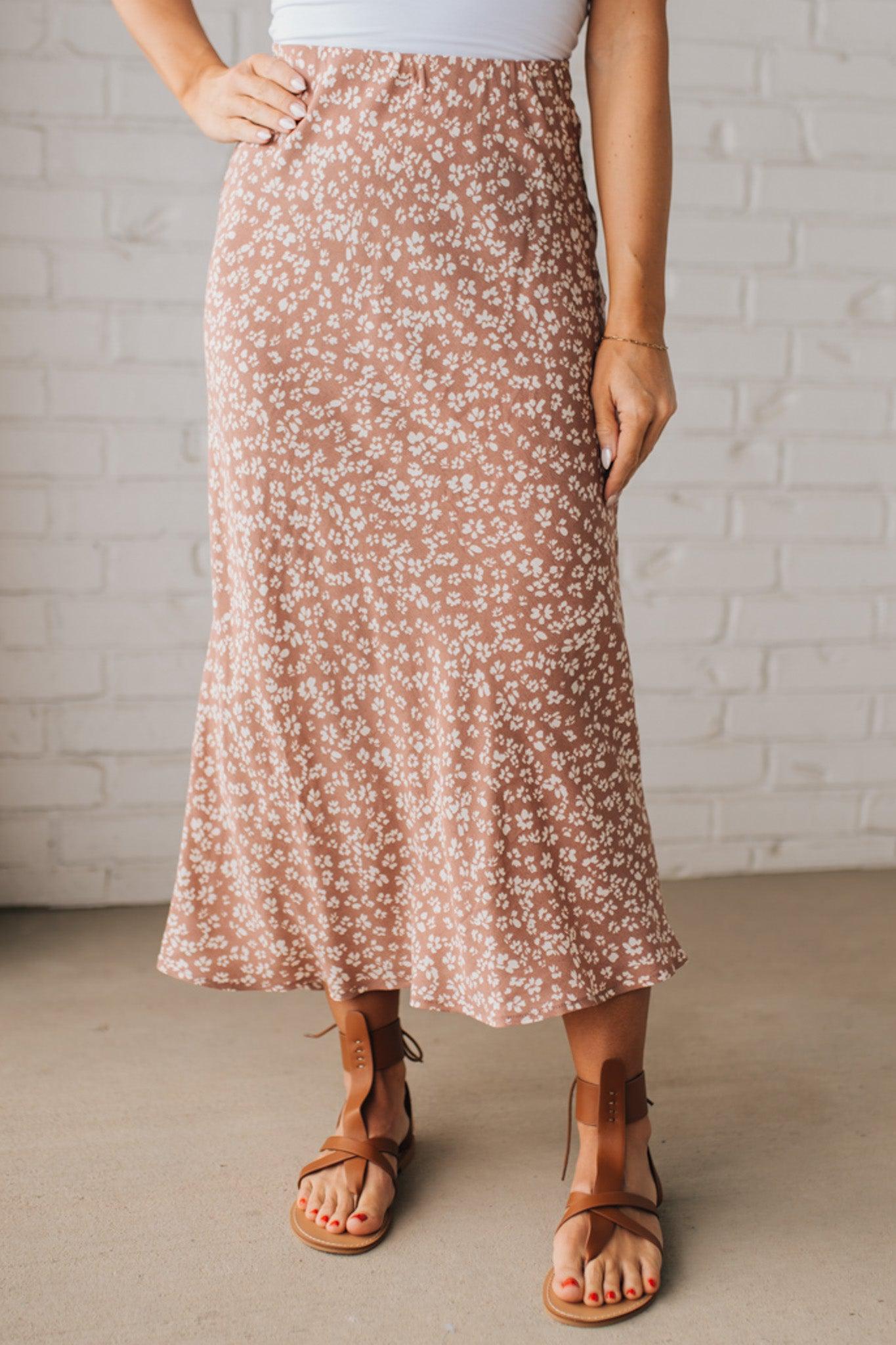 Blonde woman wearing a floral lightweight midi skirt.