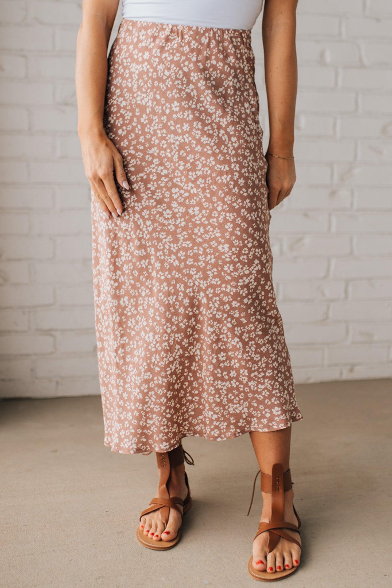 Blonde woman wearing a floral lightweight midi skirt.