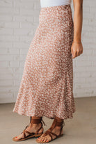 Blonde woman wearing a floral lightweight midi skirt.