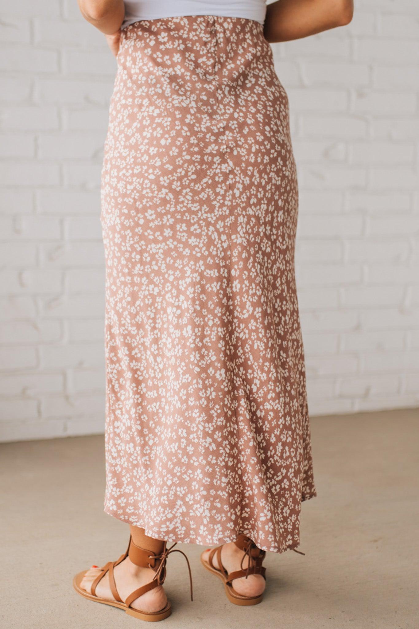 Blonde woman wearing a floral lightweight midi skirt.