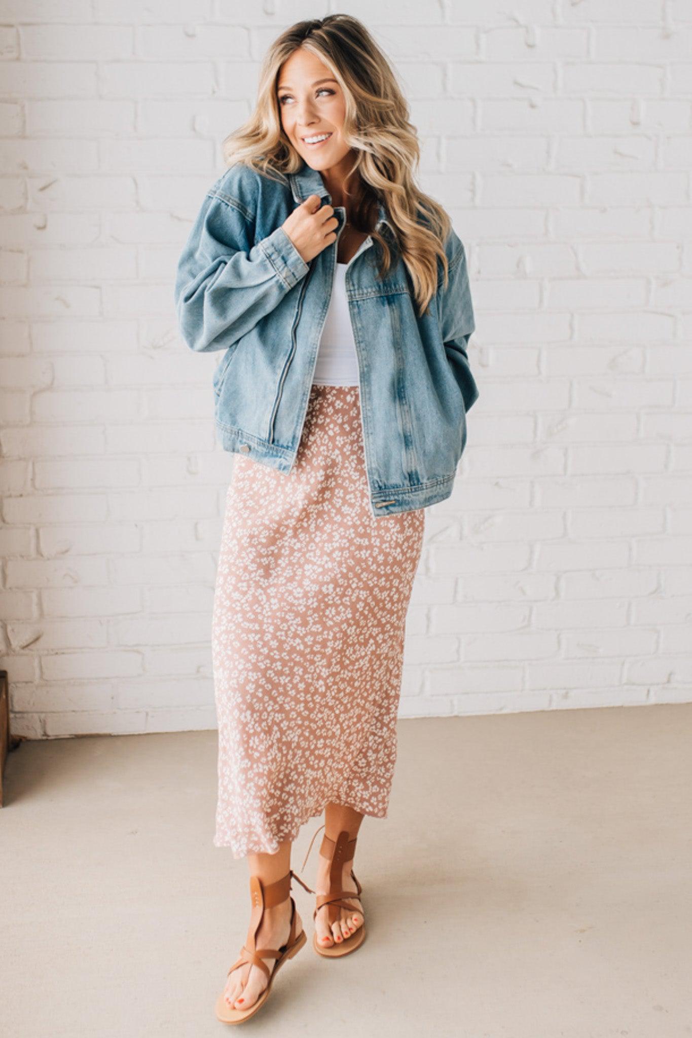 Blonde woman wearing a floral lightweight midi skirt.