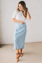 Blonde woman wearing a floral lightweight midi skirt.