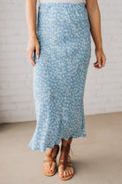 Blonde woman wearing a floral lightweight midi skirt.