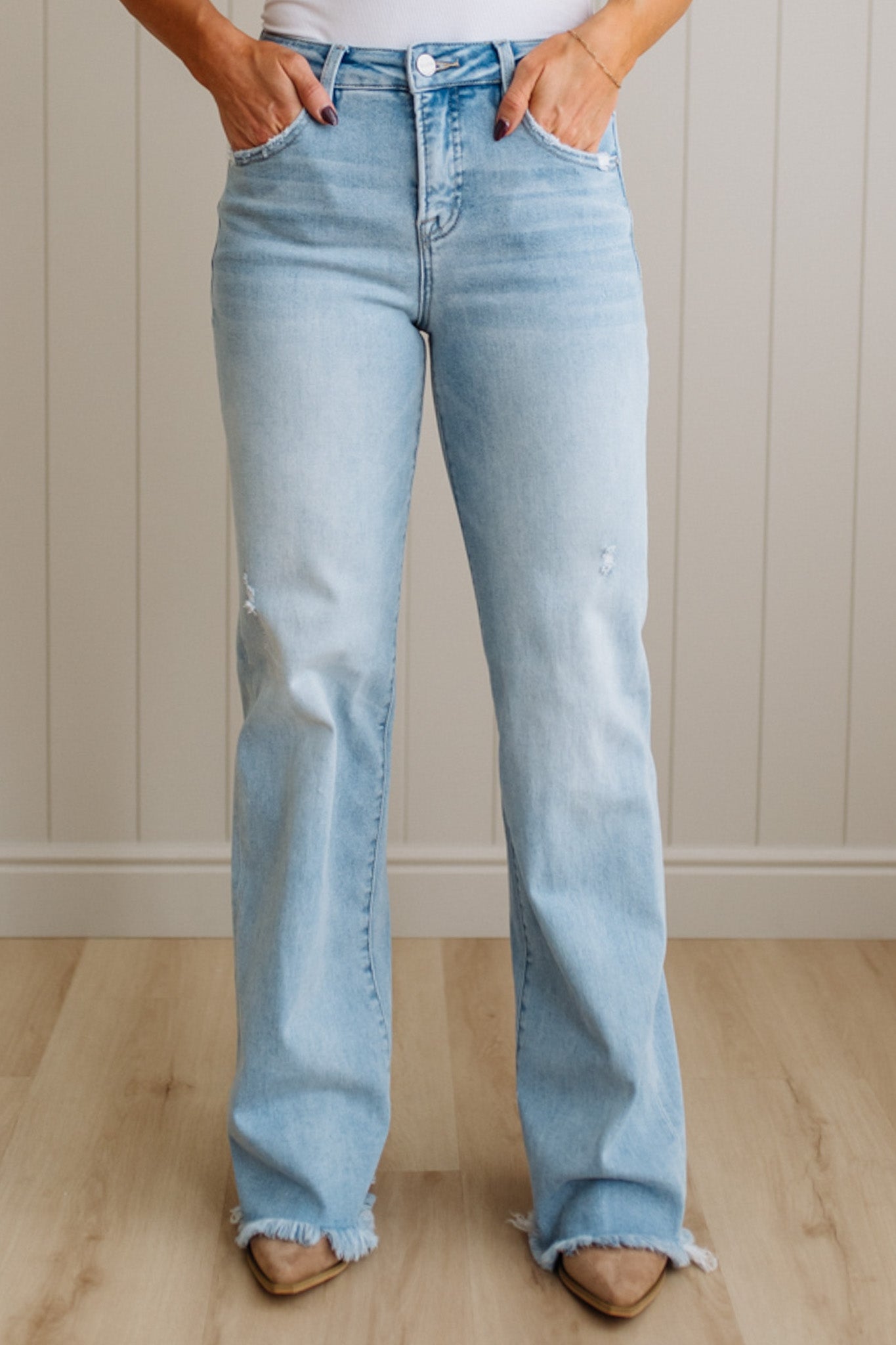 Light blue jeans worn by a person against a neutral background