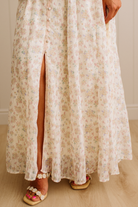 Floral dress with a slit on a neutral background