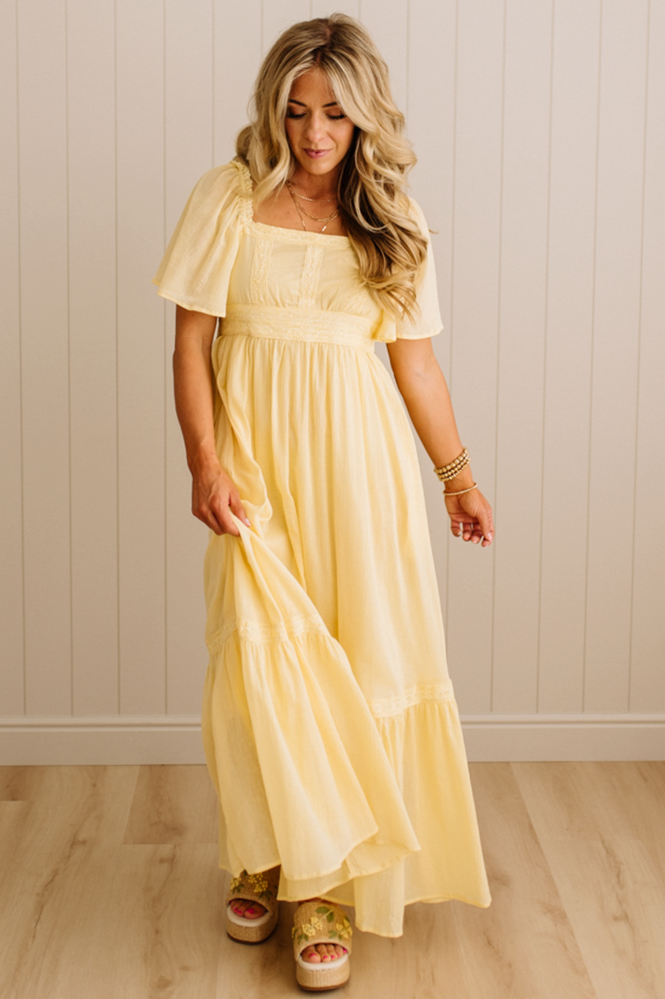 Blonde Woman Wearing a Lemon Yellow Lace Inset Flutter Sleeve Maxi Dress