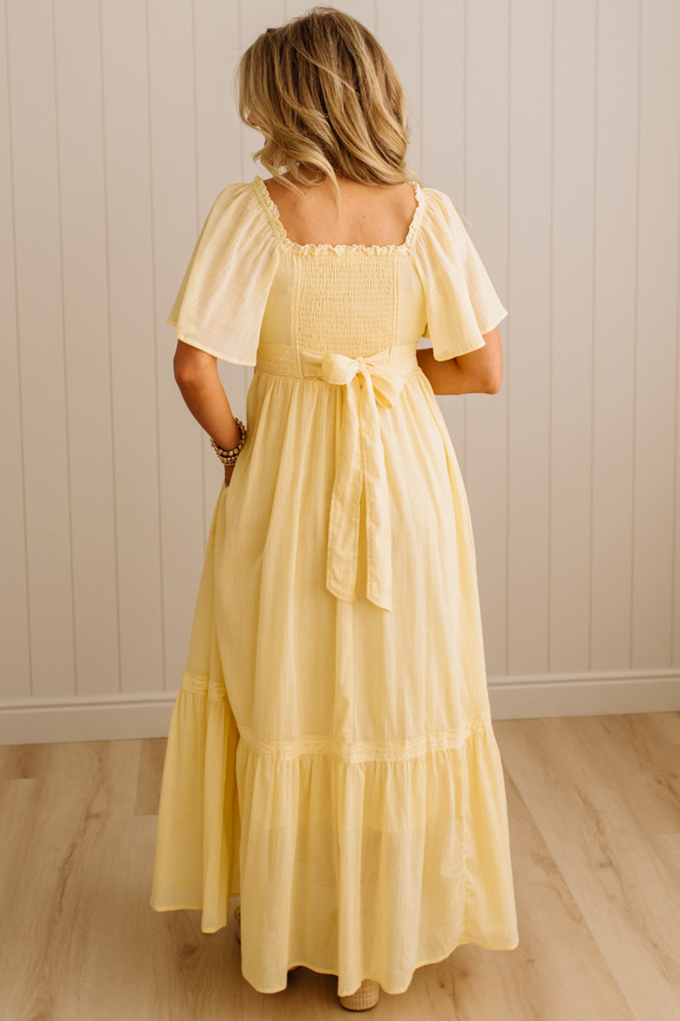 Blonde Woman Wearing a Lemon Yellow Lace Inset Flutter Sleeve Maxi Dress