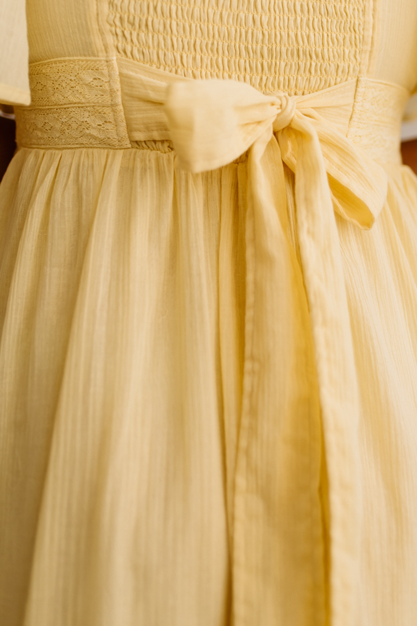 Blonde Woman Wearing a Lemon Yellow Lace Inset Flutter Sleeve Maxi Dress