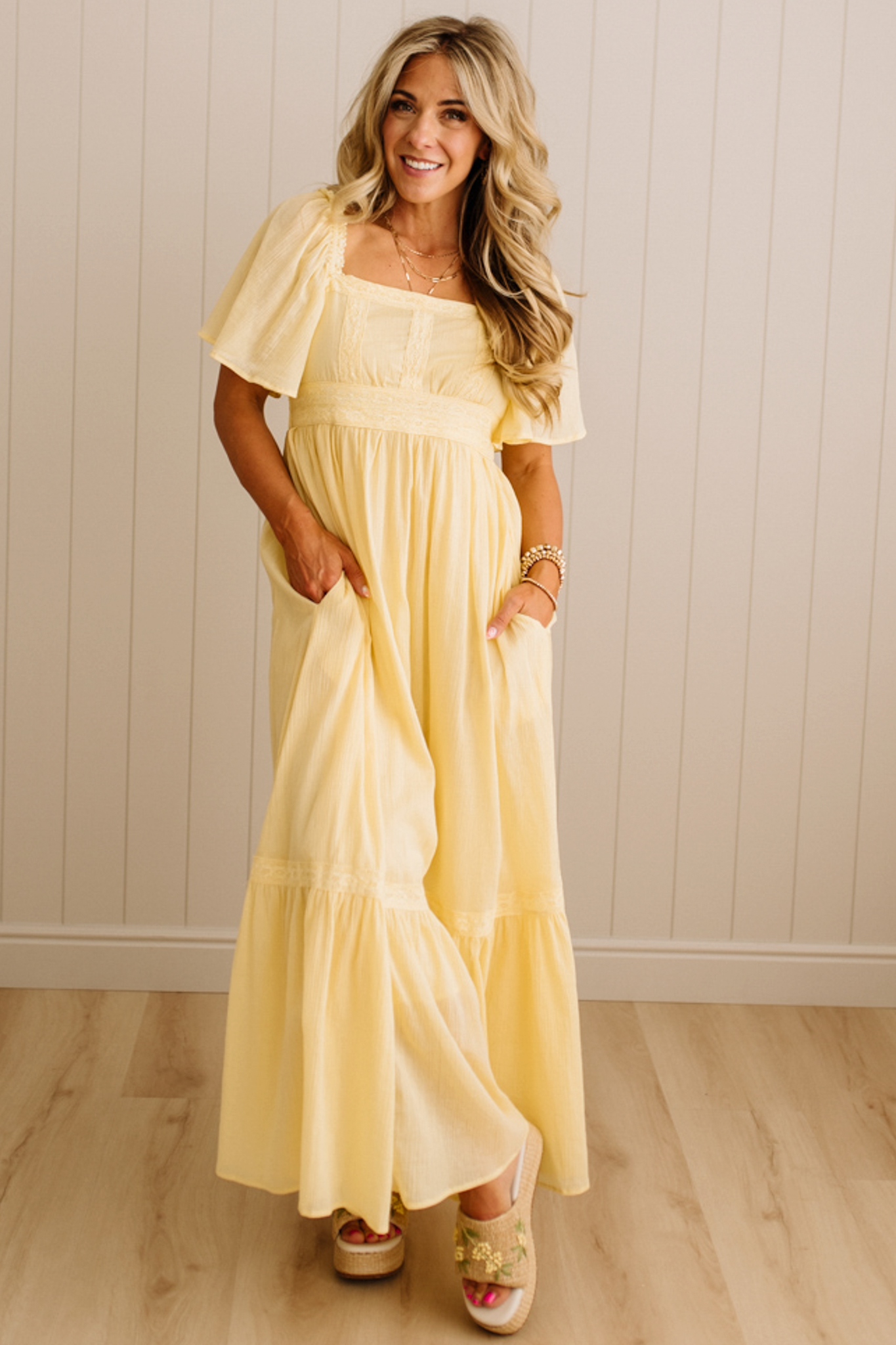 Blonde Woman Wearing a Lemon Yellow Lace Inset Flutter Sleeve Maxi Dress