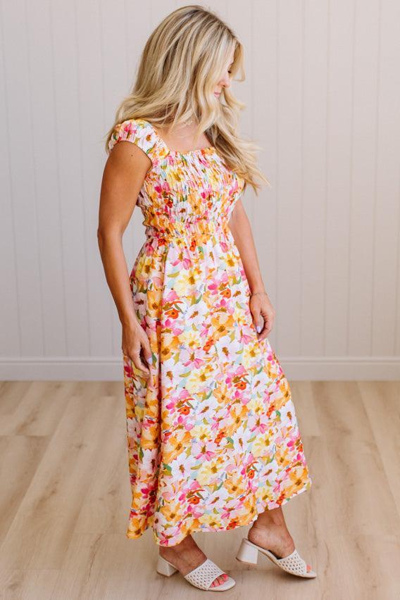 DARLING FLORAL MAXI DRESS FEATURES:
- COTTON FLORAL PRINT FABRICATION
- FLORAL EMBROIDERY MOTIF AT FRONT BUST
- RUFFLED SHOULDERS
- HIDDEN SIDE ZIPPER
- SIDE POCKETS
- SMOCKED BACK BODICE
- LACE INSET FLOUNCE
- FULL LINING