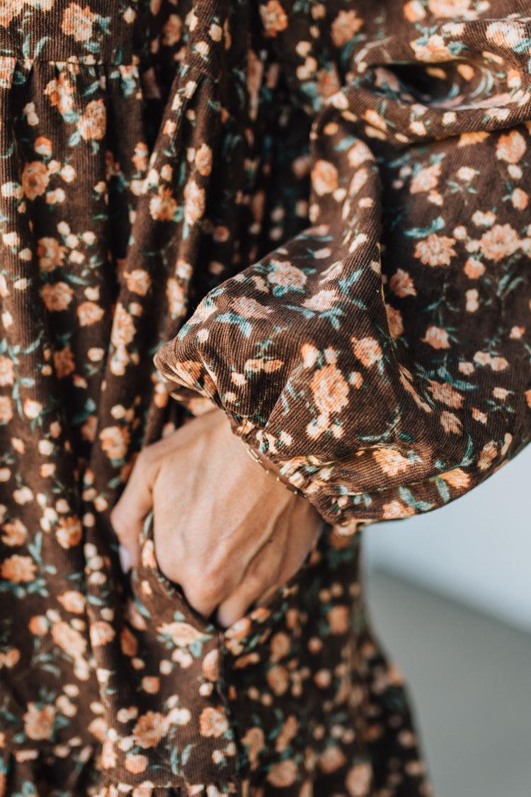 Close-up of a brown floral dress with a blurred background