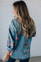 blonde girl modeling a long sleeve button front denim top with pink floral pattern