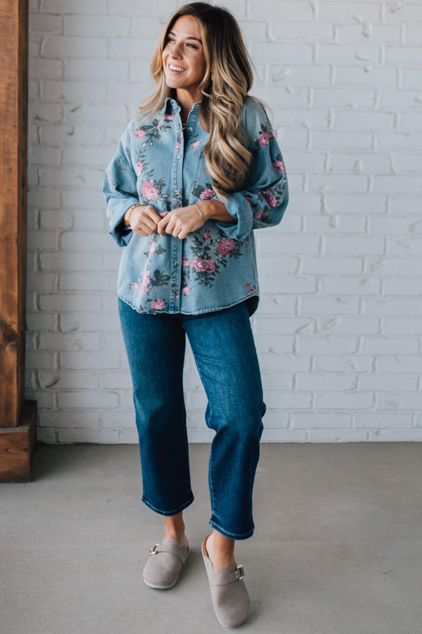 blonde girl modeling a long sleeve button front denim top with pink floral pattern