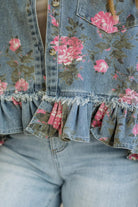 Denim jacket with floral patterns and ruffled hem