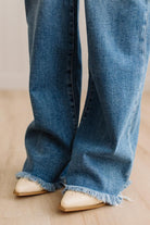Finged jeans close up with cream embroidered western inspired slip on heel boots.