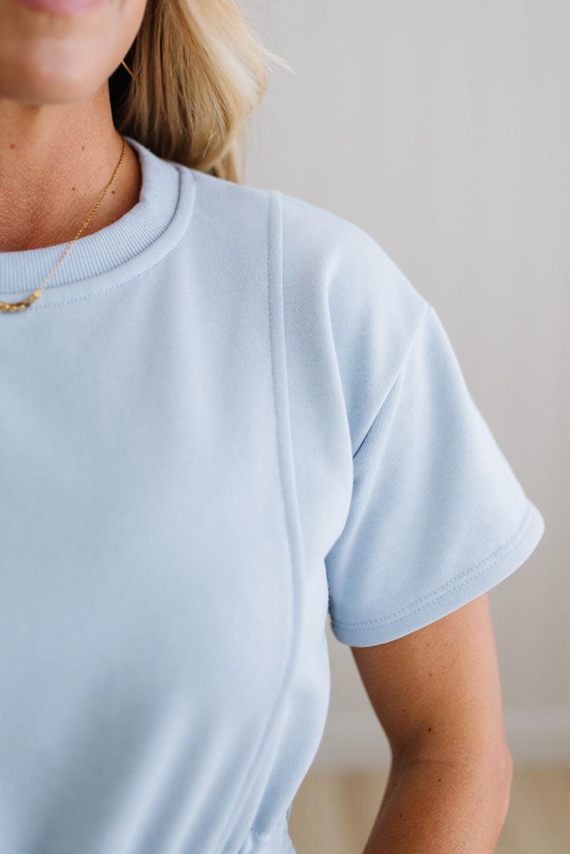 Light blue t-shirt worn by a person with a neutral background