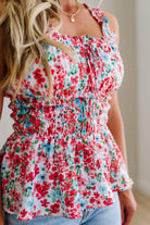 Woman wearing a floral top with a blurred background