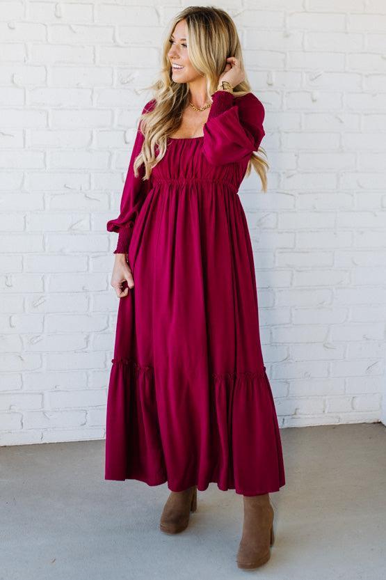 Blonde Woman Wearing a Gathered Long Sleeve Maxi Dress in the color Cherry Merlot.