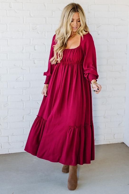 Blonde Woman Wearing a Gathered Long Sleeve Maxi Dress in the color Cherry Merlot.