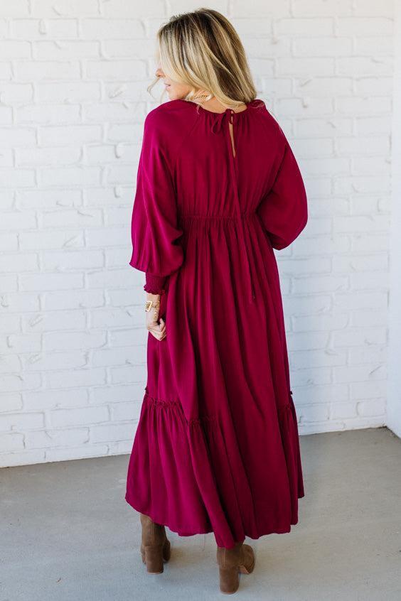 Blonde Woman Wearing a Gathered Long Sleeve Maxi Dress in the color Cherry Merlot.