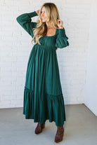 Blonde Woman Wearing a Gathered Long Sleeve Maxi Dress in the color Deep Forest.