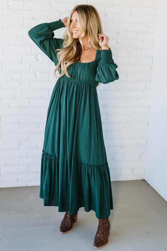 Blonde Woman Wearing a Gathered Long Sleeve Maxi Dress in the color Deep Forest.