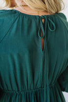 Blonde Woman Wearing a Gathered Long Sleeve Maxi Dress in the color Deep Forest.