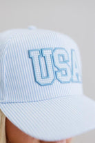 Light blue striped cap with 'USA' text on a neutral background