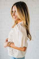 Blonde woman wearing a Mix Media Sequin Crochet Bodice Woven Blouse in cream.