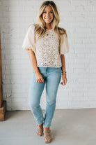 Blonde woman wearing a Mix Media Sequin Crochet Bodice Woven Blouse in cream.