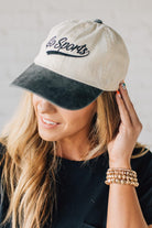 Blonde woman wearing a hat with Go Sports Embroidered at the front of the  Two Tone Baseball Cap.