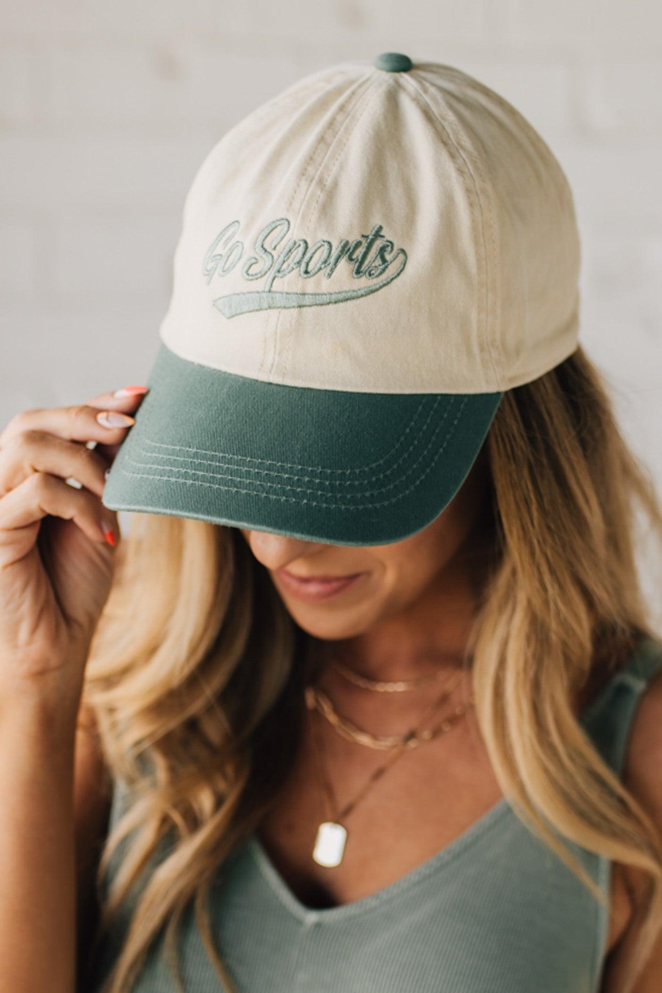 Blonde woman wearing a hat with Go Sports Embroidered at the front of the  Two Tone Baseball Cap.