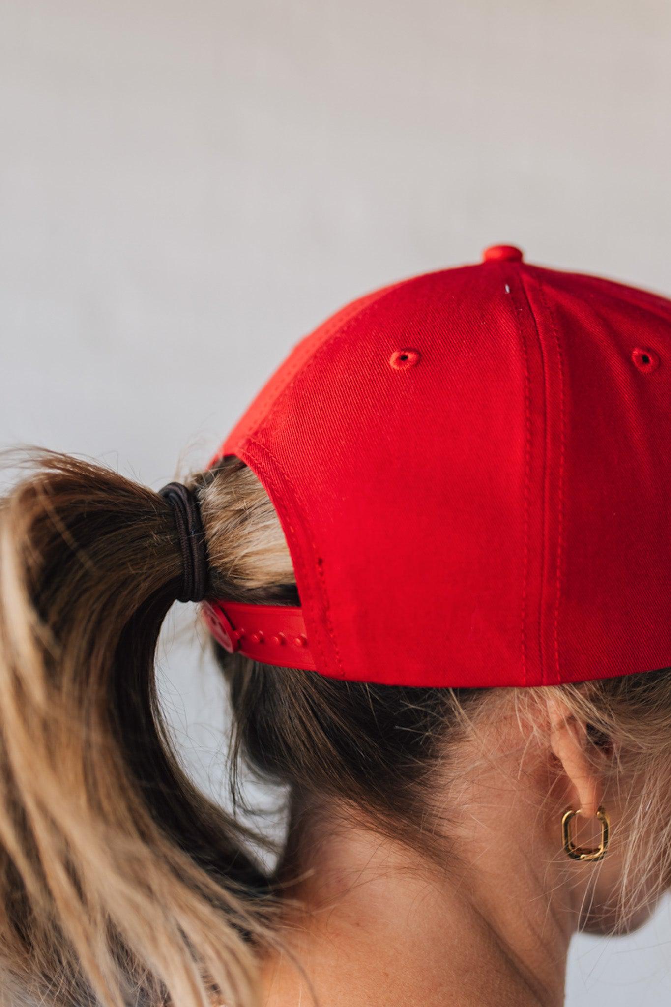 Red hat on a blonde woman with Americana theme.