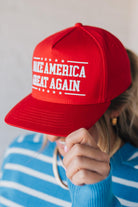 Red hat on a blonde woman with Americana theme.