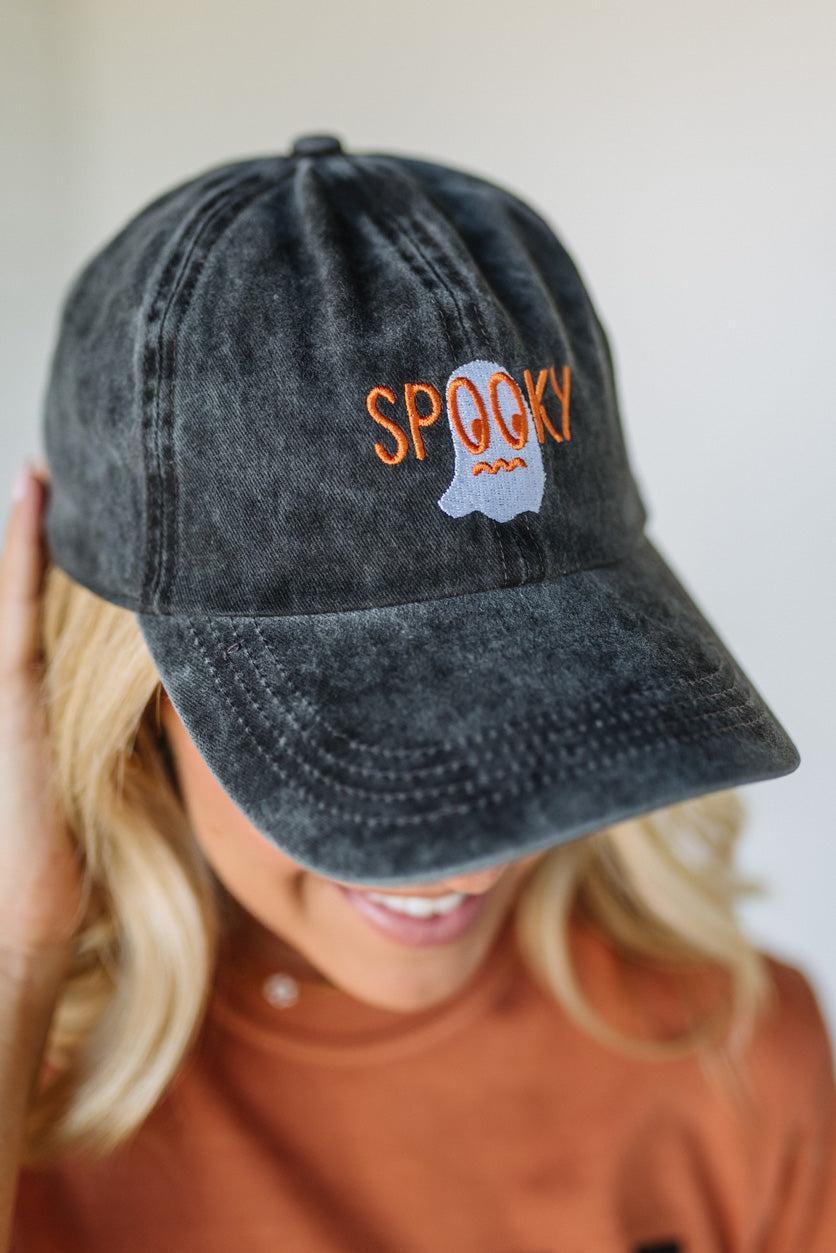 Black distressed cap with 'SPooky' embroidered on it, worn by a person.