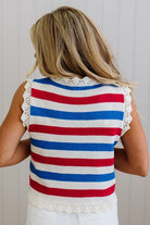 Person wearing a red, white, and blue striped sleeveless top with lace trim.