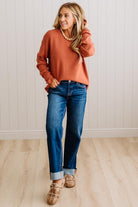 Blonde woman wearing a solid waffle texture sweater with drop shoulder seams and crewneck.