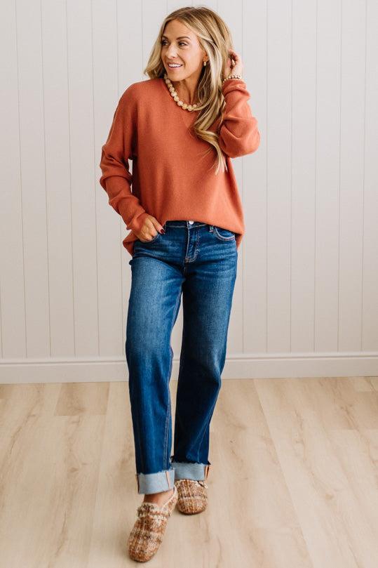 Blonde woman wearing a solid waffle texture sweater with drop shoulder seams and crewneck.